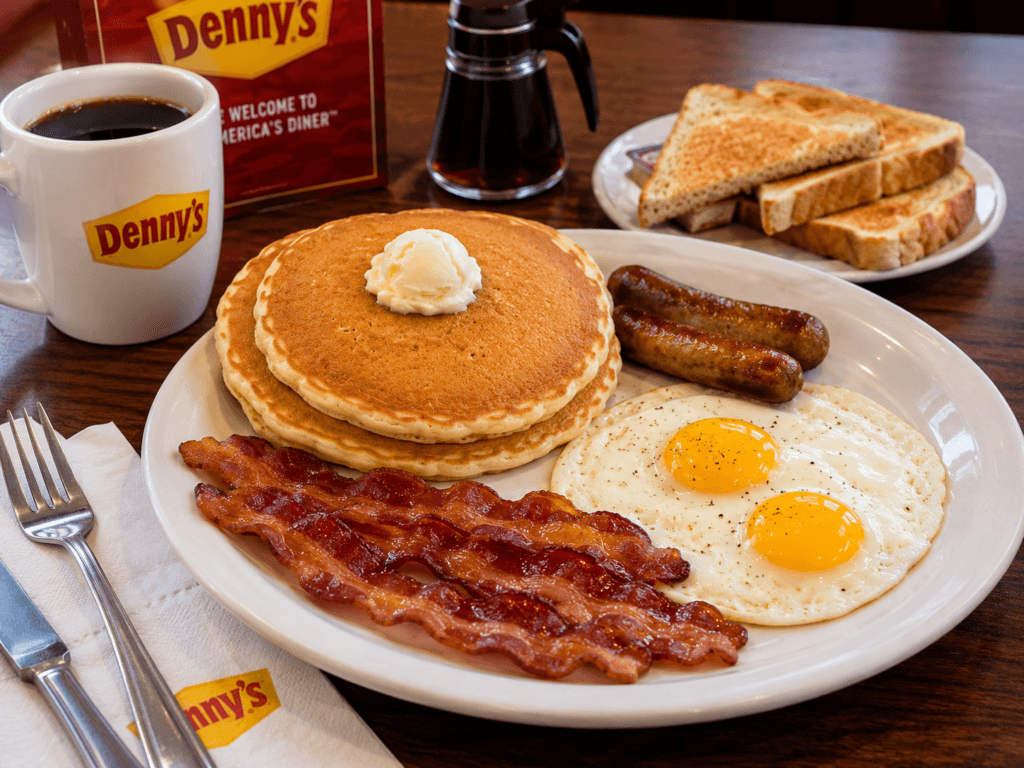 Denny's breakfast specials spread with Grand Slam pancakes eggs and bacon